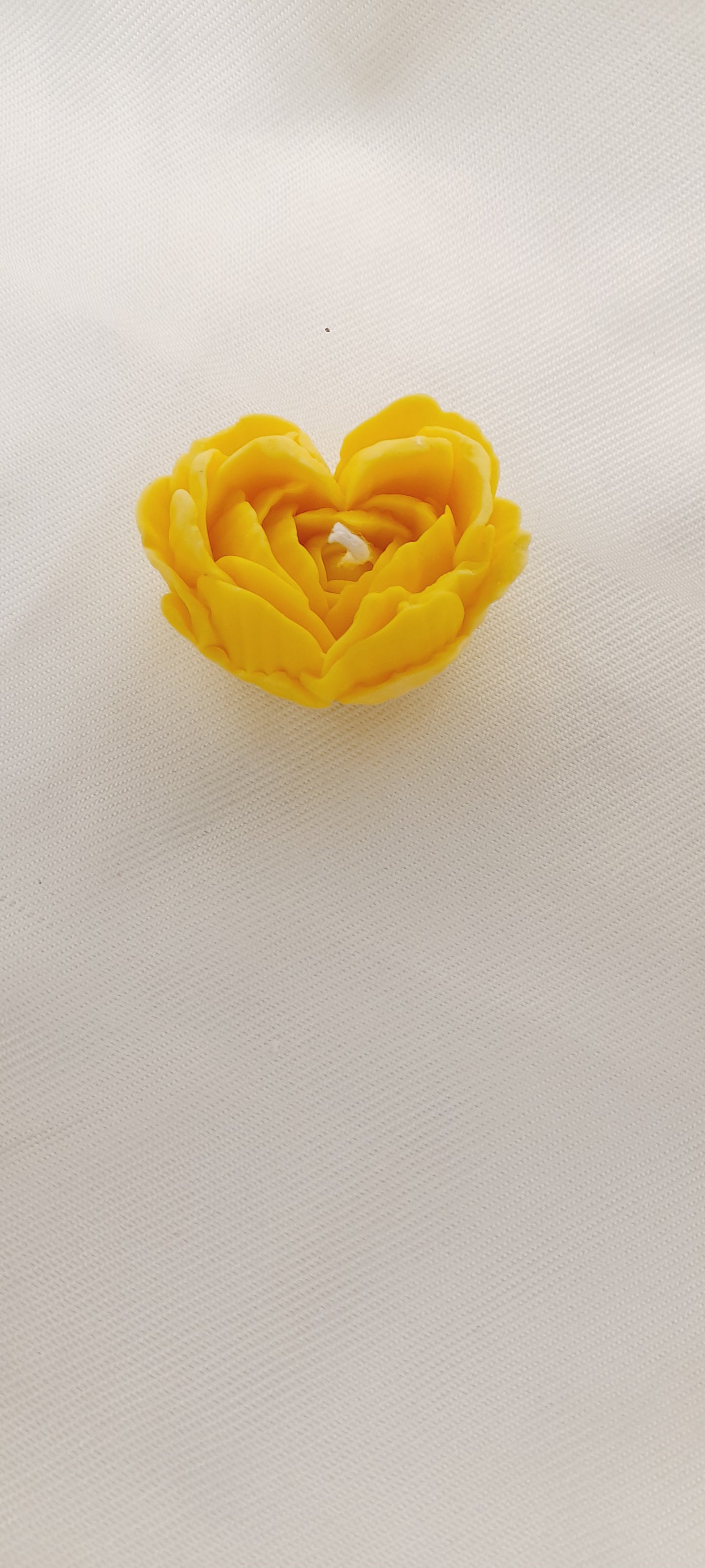 Handmade yellow heart flower candle.